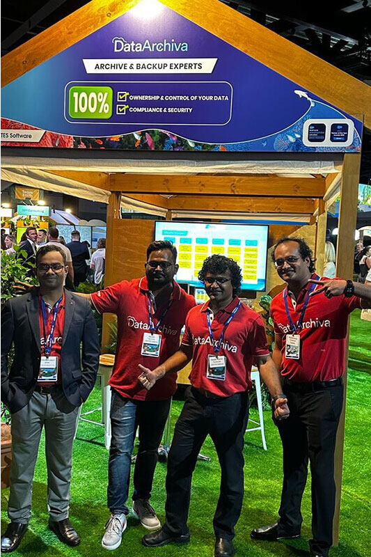 Team DataArchiva stands in front of their Platinum Sponsor booth at Salesforce World Tour Sydney 2023