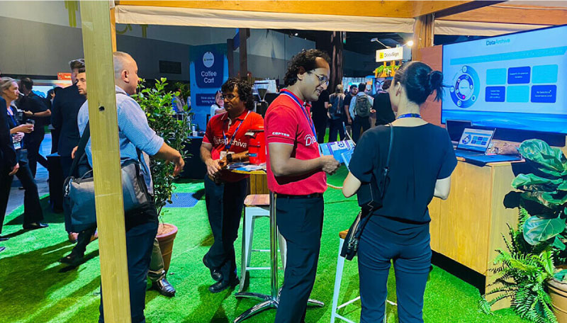 Experts of DataArchiva interact with Salesforce World Tour Sydney 2023 attendees at their Platinum Sponsor booth