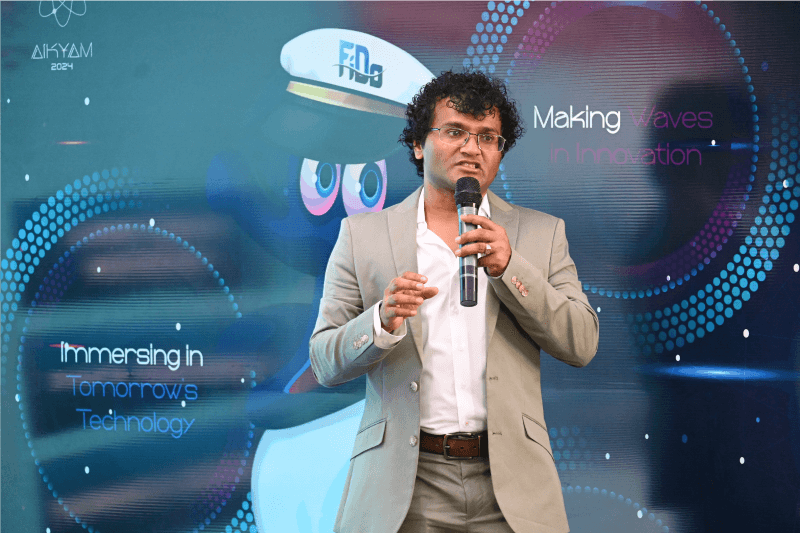 Harish Kumar delivers a keynote during AIKYAM 2024 regarding the future of tech